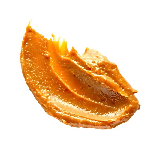 Cuillerée de Beurre de Cacahuète RACINES BIO à la texture crémeuse, parfaite pour tartines ou recettes sucrées-salées.