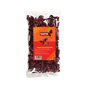 Transparent pouch of whole red Bissap TANTIE, 100g on a green background. Orange and red packaging.