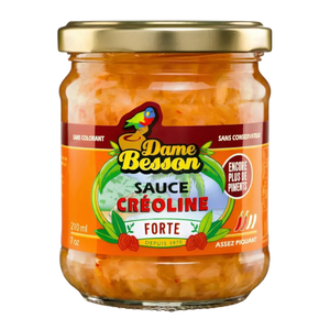 Barattolo di salsa creola piccante Dame Besson su sfondo nero. Etichetta arancione e verde.
