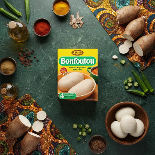 Farine d'igname BONFOUTOU - Fufu posée sur table avec ignames, épices et légumes africains, parfaite pour plats traditionnels savoureux.