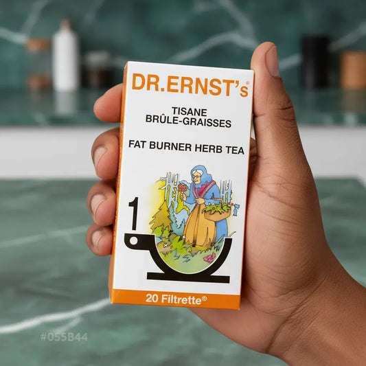 Main tenant une boîte de tisane brûle-graisses DR ERNST'S, 20 sachets, infusion aux plantes pour favoriser la perte de poids et le bien-être.
