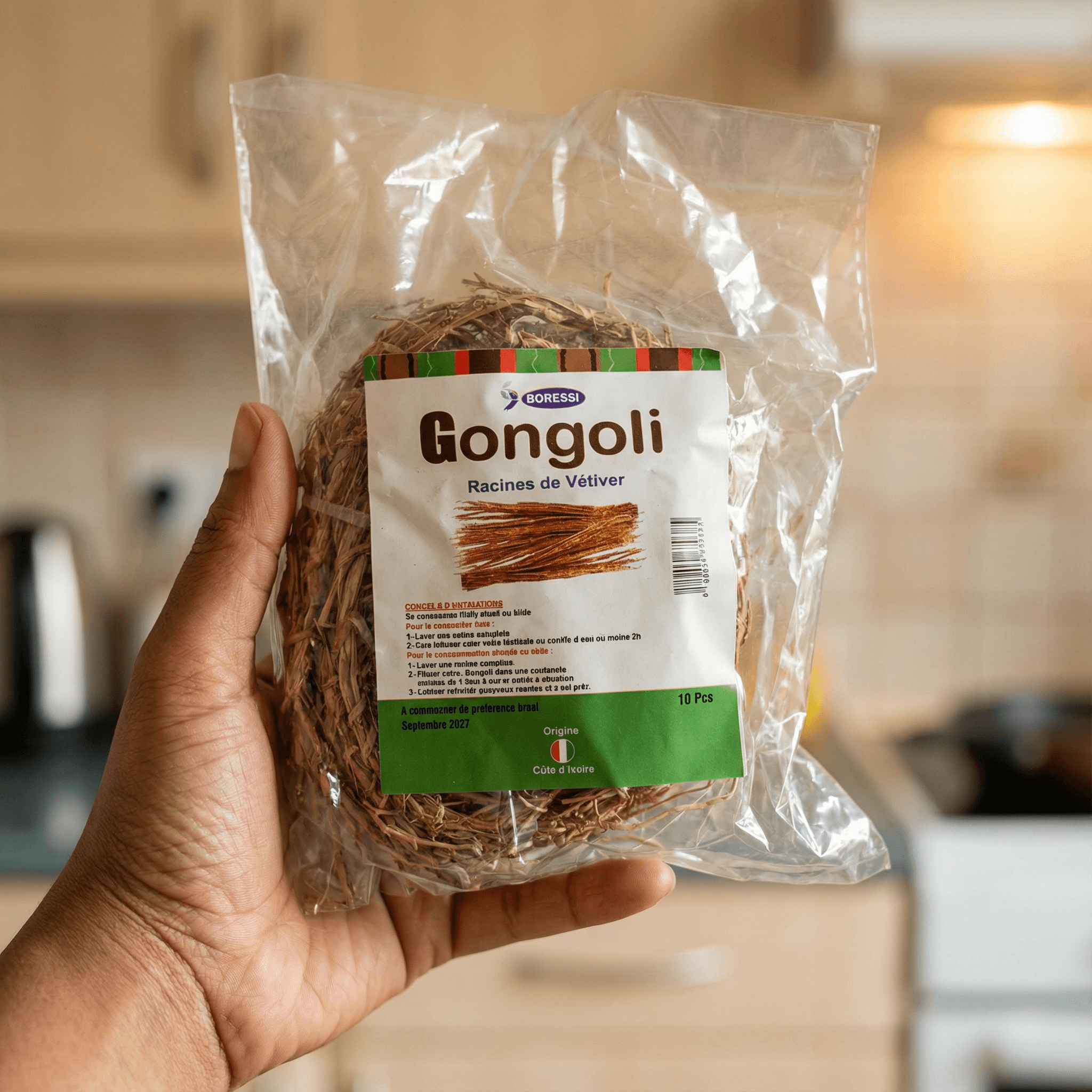 Main tenant un sachet de Gongoli Infusion - Afrique Bien-être, racines de vétiver naturelles, produit traditionnel pour infusion apaisante.