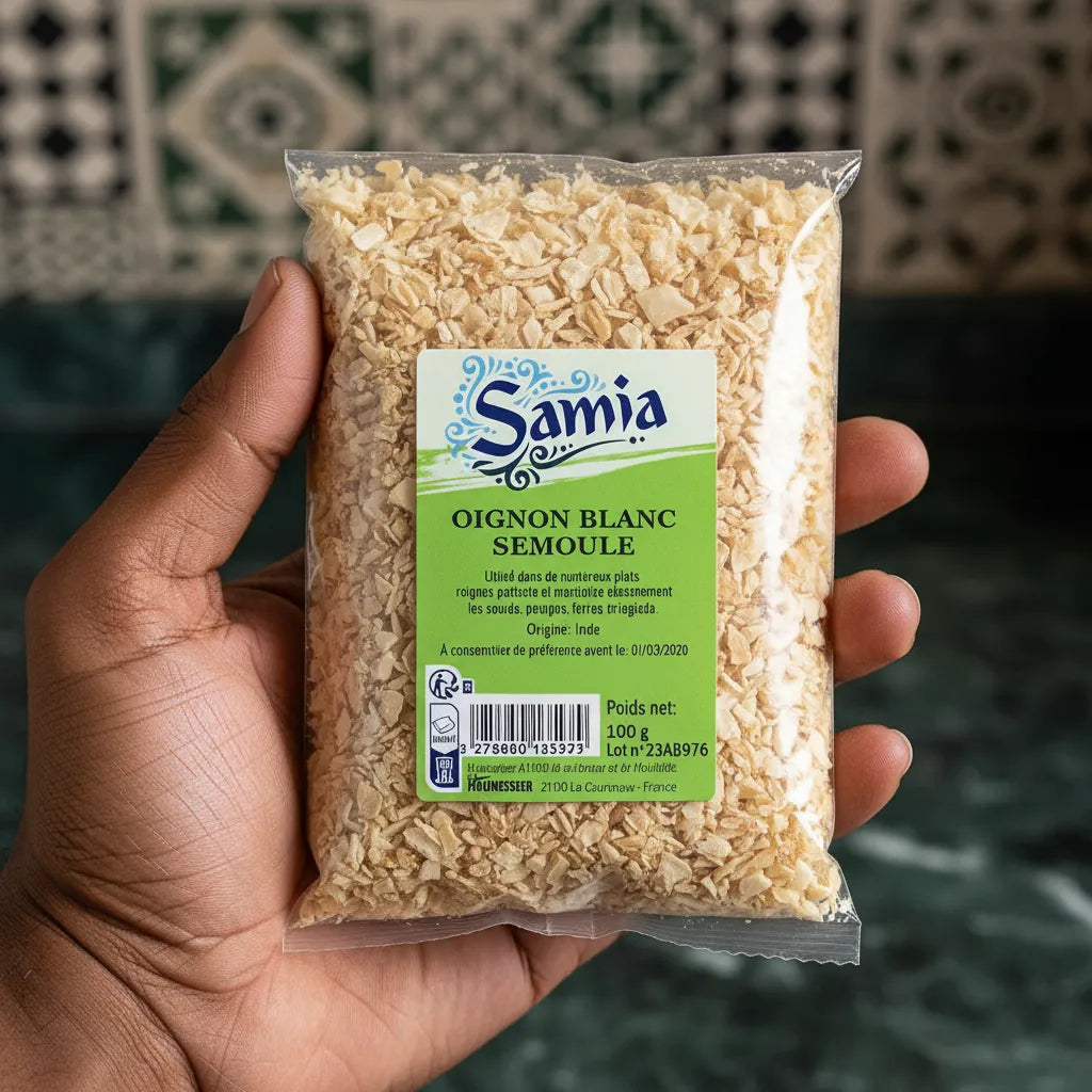 Main tenant un sachet de semoule d'oignon blanc SAMIA, épice pratique et savoureuse pour l'épicerie salée et la cuisine rapide.