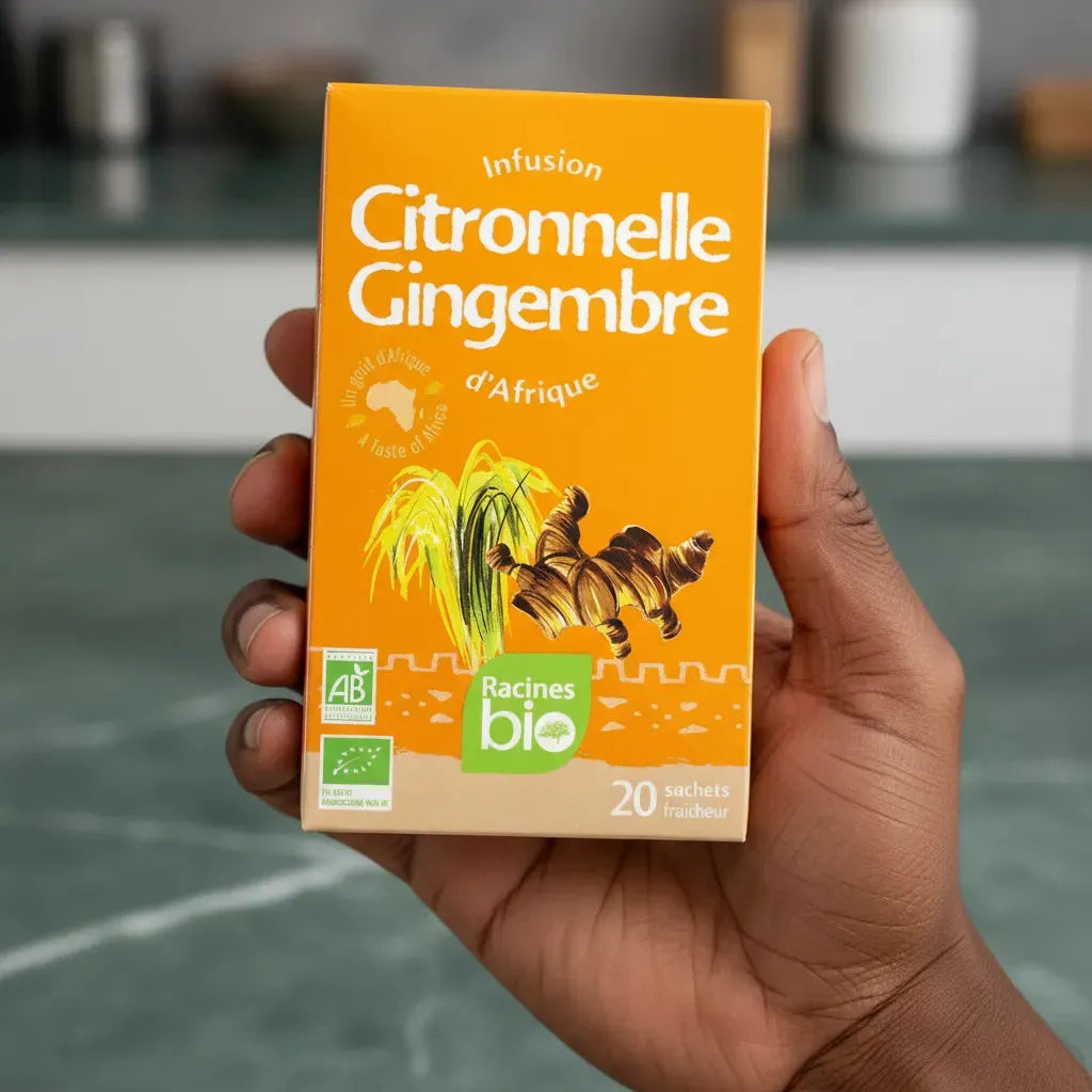 Main tenant une boîte d'infusion citronnelle gingembre bio RACINES, boisson bio aux saveurs rafraîchissantes et épicées, 20 sachets.