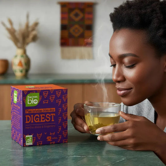 Femme savourant une tasse d'infusion bien-être Digest BIO Racines, arômes apaisants de menthe douce et gingembre pour digestion naturelle.