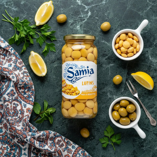 Lupins en bocal SAMIA - présentation gourmande avec citron, olives et herbes fraîches sur fond marbré, idéal pour apéritifs.