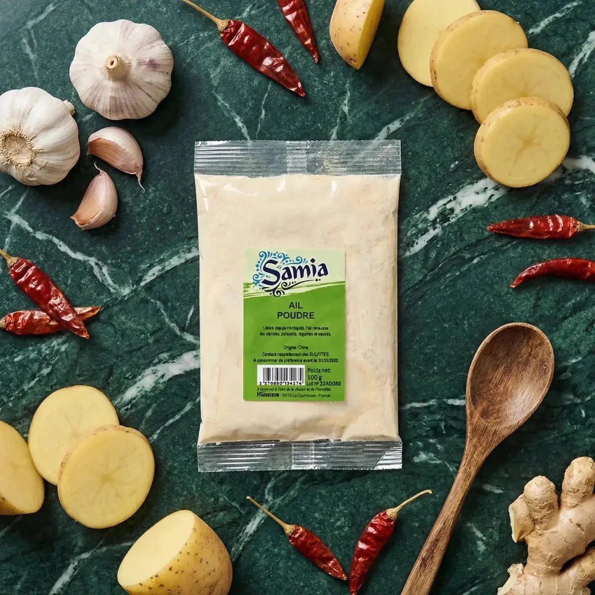 Sachet poudre d'ail Samia 100g, ail, piments, gingembre, pommes de terre sur fond vert marbré.
