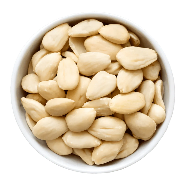Whole blanched almonds in a white bowl, green background.