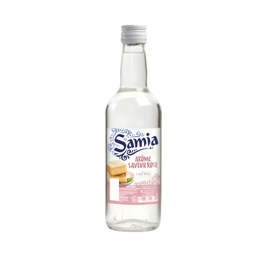 Botella de aroma de rosa SAMIA, líquido incoloro, etiqueta azul y rosa.
