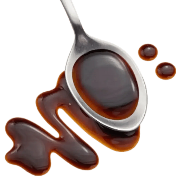 MAGGI sauce spoon overflowing, on a green background. Shiny drops. Intense aroma.