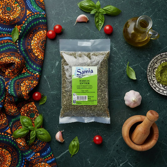 Basilic entier SAMIA - Aromatique et Intense entouré d’ingrédients frais comme ail, tomates et huile d’olive, parfait pour cuisine épicée.