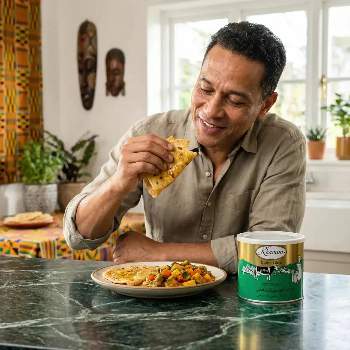 A man eating a flatbread with Khanum ghee butter. Green and gold metal tin.