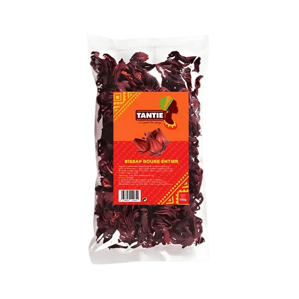 Sachet transparent de Bissap rouge entier TANTIE, 100g sur fond vert. Emballage orange et rouge.