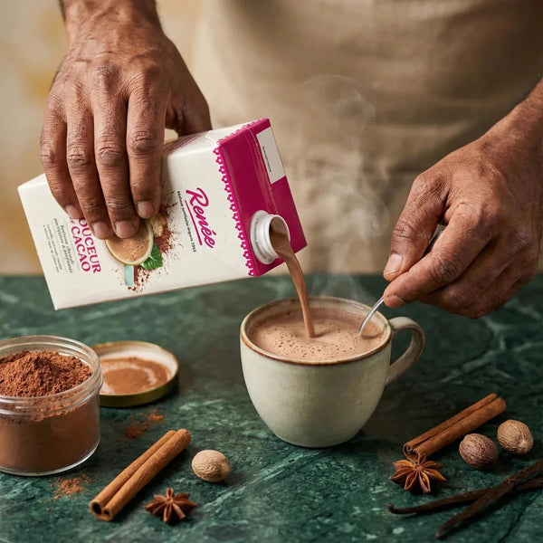 Creamy cocoa drink by Renée, poured into a coffee cup, with spices.