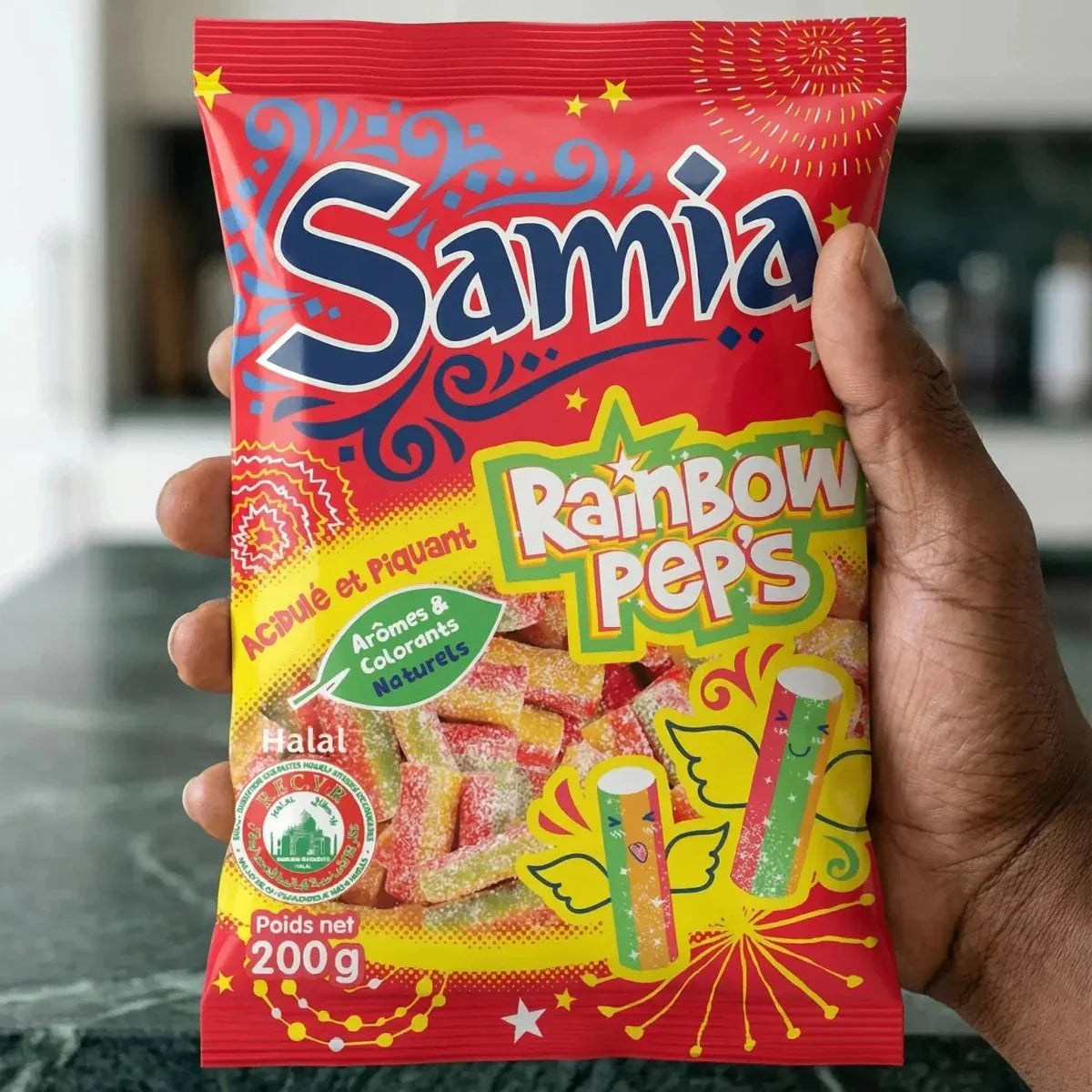 Red bag of Rainbow Peps Halal sour candies SAMIA, 200g, held in hand.