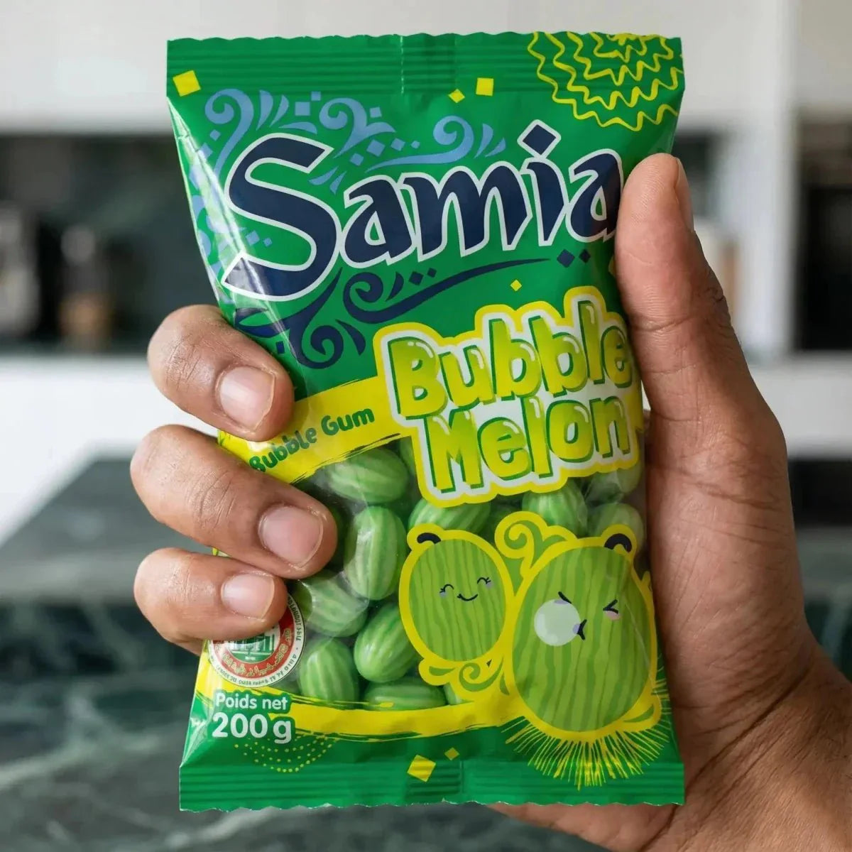 Package of Samia halal Bubble Melon candies, 200g, held in a hand. Green packaging.