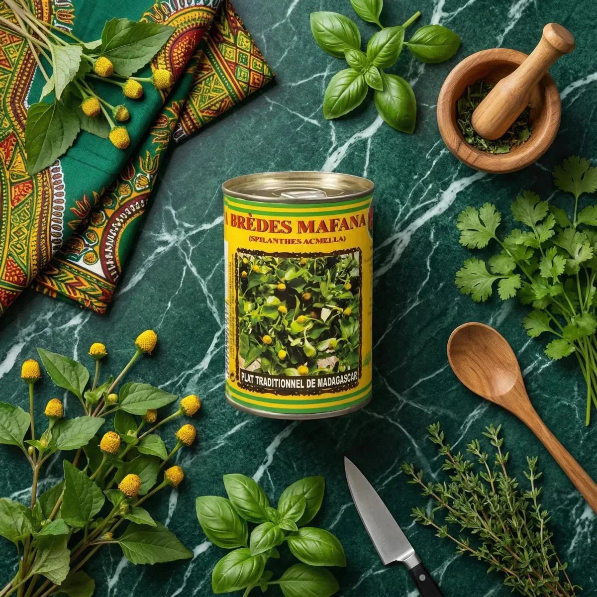 Brèdes Mafana Codal 400g canned food on a marbled green background with fresh herbs, African fabric.