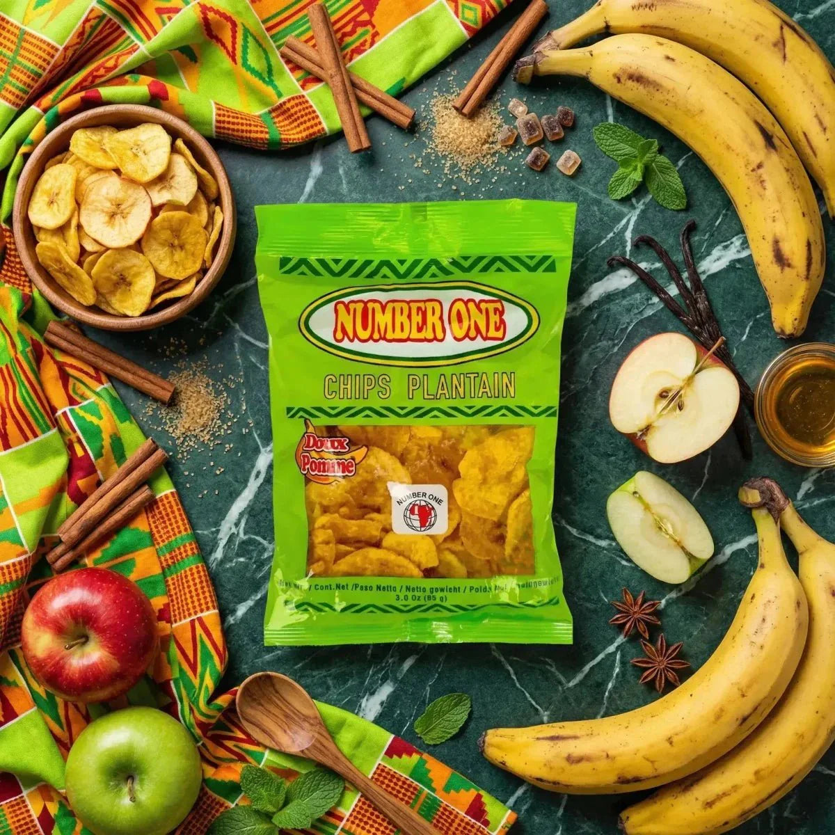 Plantainchips Nr. 1: smakelijke foto met fruit, kruiden en een kom chips op een groene tafel.