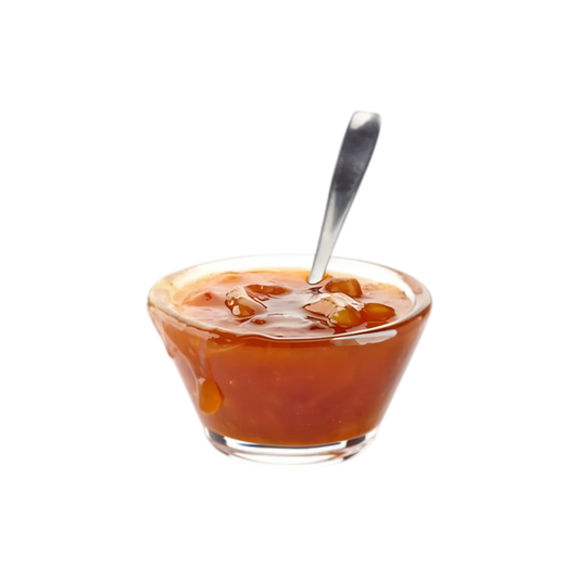 Confiture Banane Miel Guyane servie dans une coupelle en verre avec cuillère, parfaite pour crêpes, pains et douceurs sucrées.