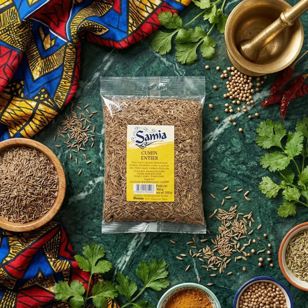 Whole SAMIA cumin displayed in its packaging on a marble table, surrounded by spices.