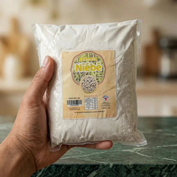 A bag of Number One brand cowpea flour held in a hand, against a kitchen background.