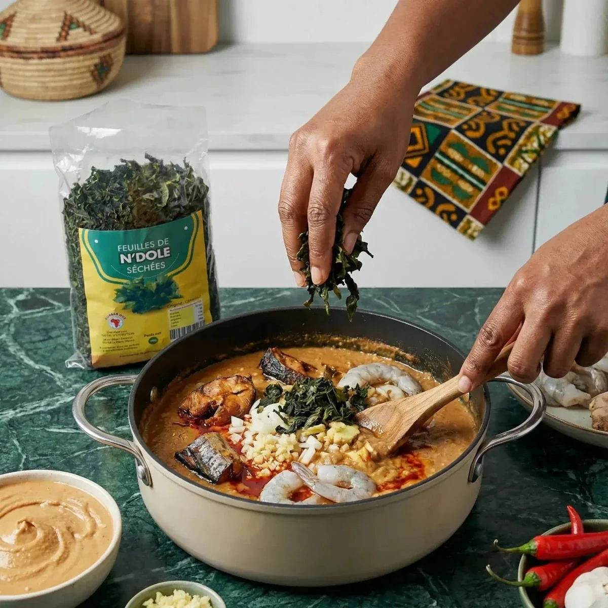 Kitchen NUMBER ONE: a person adds dried Ndolé leaves (100g) to a dish.