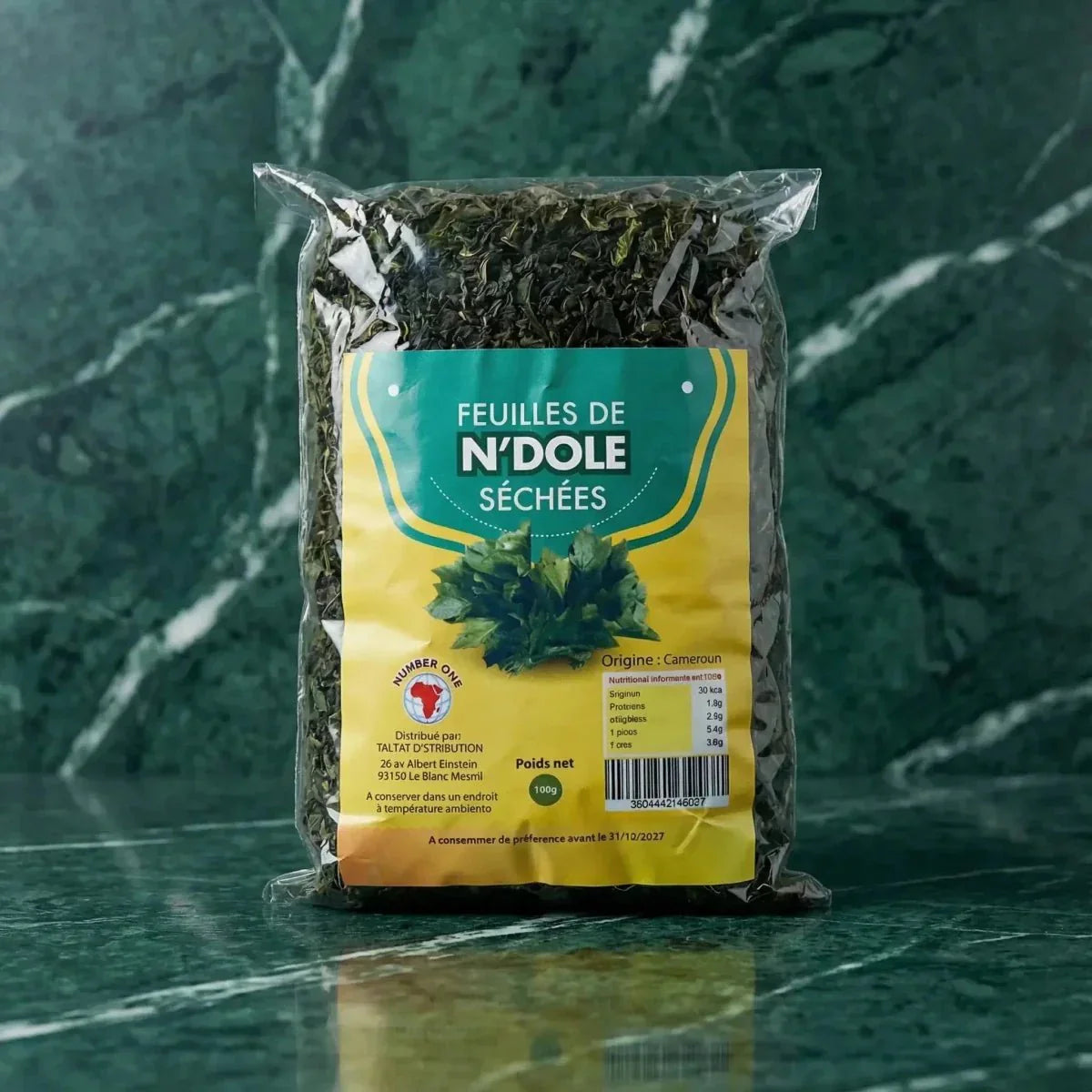 Packet of dried Ndolé leaves NUMBER ONE on a marbled green background.