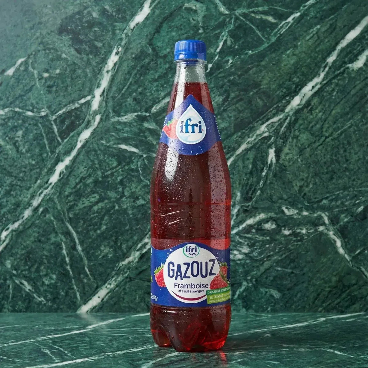 Sparkling raspberry soda from Gazouz, with water droplets on the bottle.