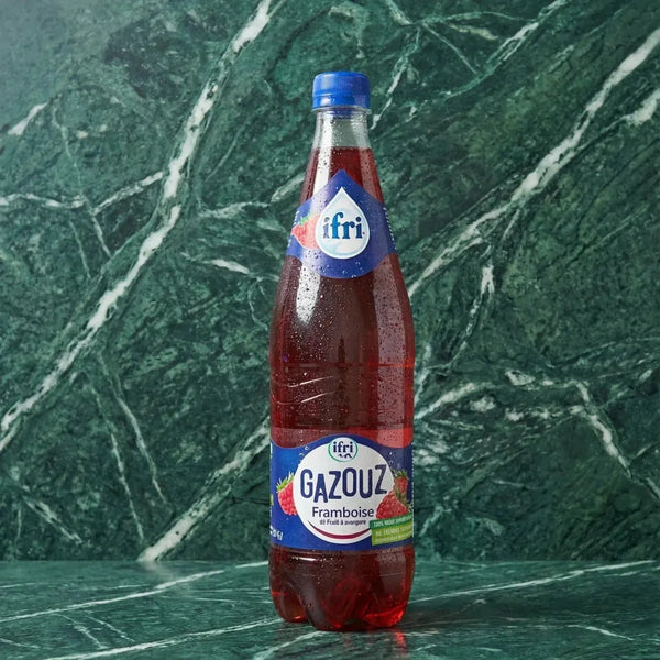 Sparkling raspberry soda from Gazouz, with water droplets on the bottle.