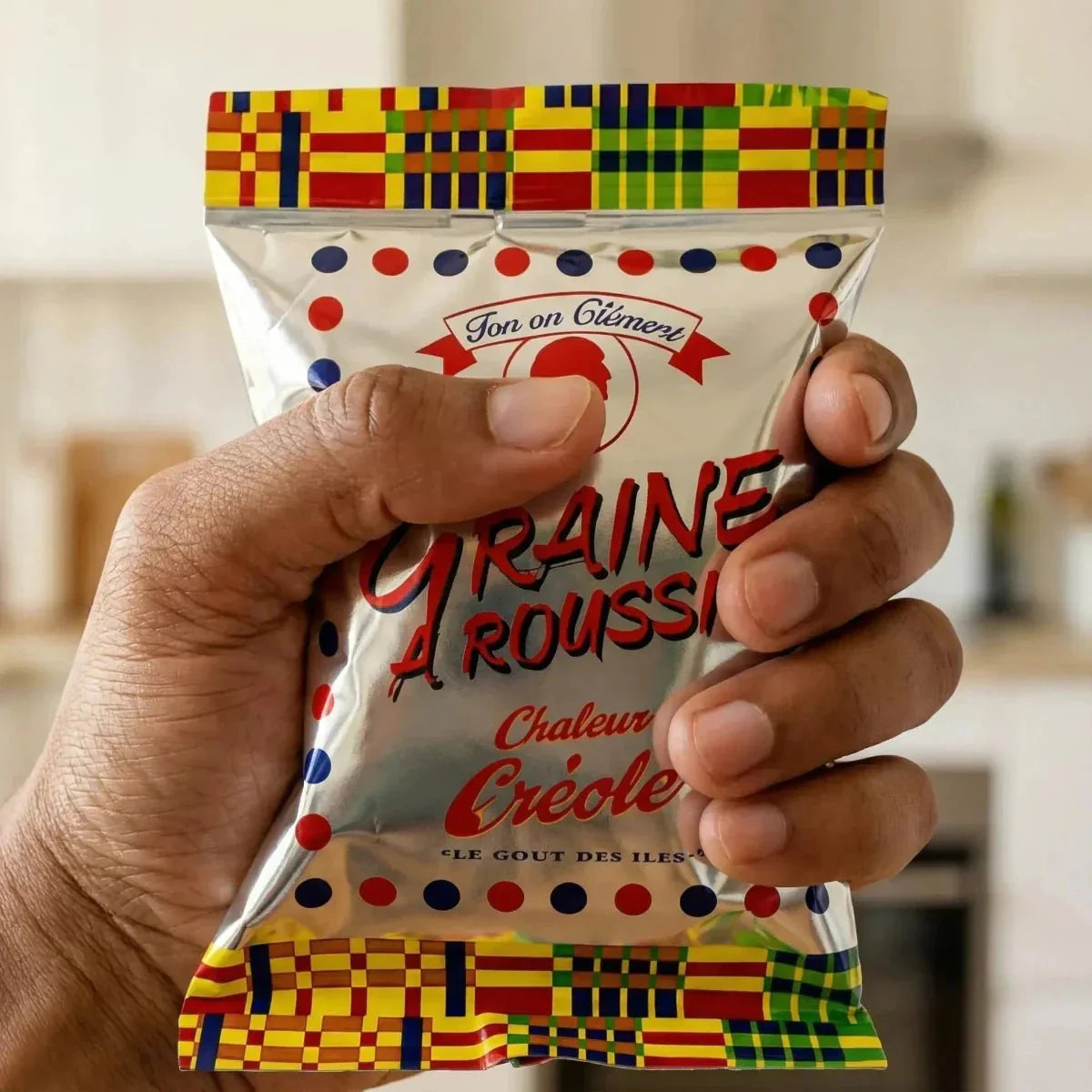 A 100g bag of Tonton Clément Browning Seeds held in one hand. Colorful packaging.