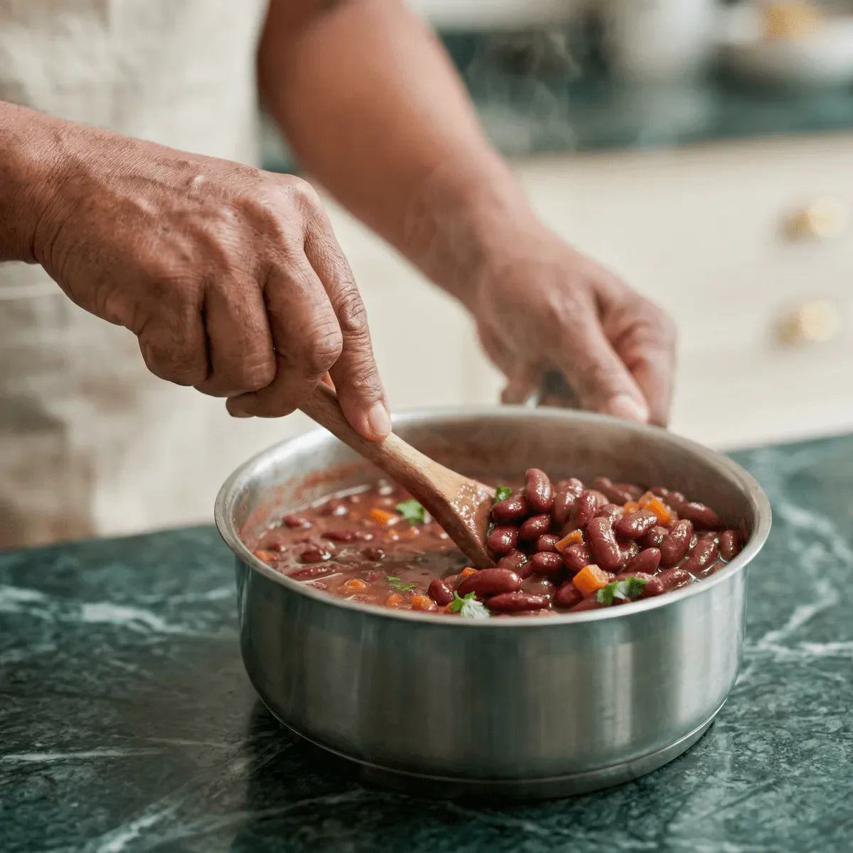 GOYA red beans cooking. A person stirs in a steaming pot.