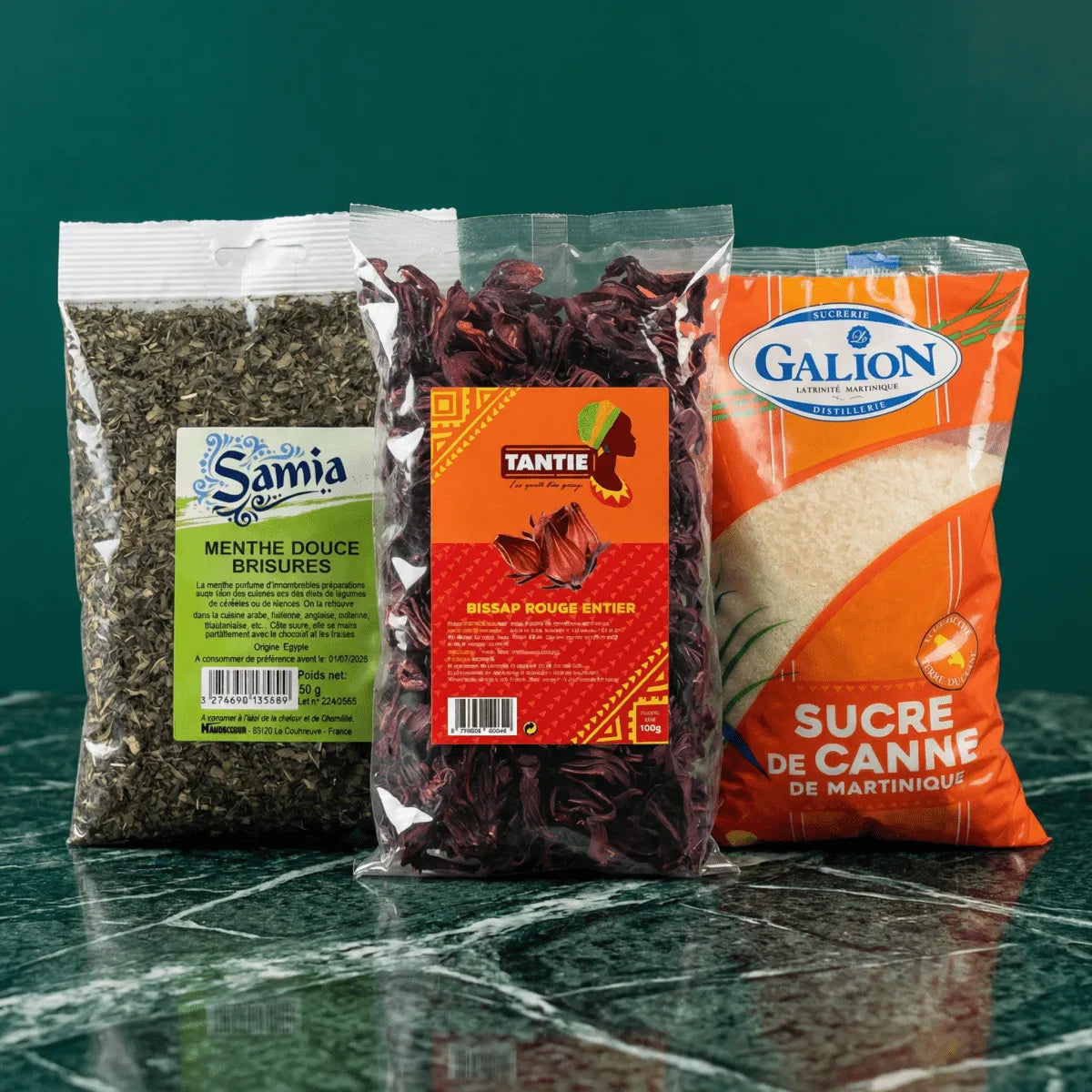 Three packages on a table: Samia mint, Tantie red Bissap, and Galion sugar from Martinique.