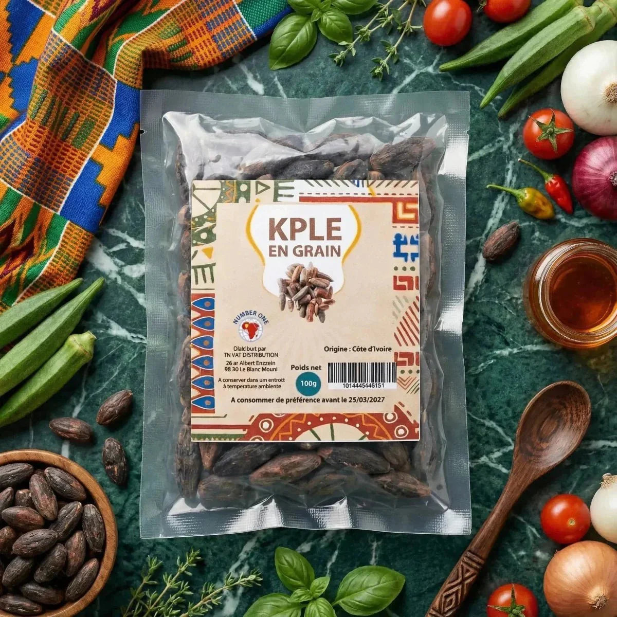 Whole NUMBER ONE Kpele in a bag, green paste with vegetables and utensils. African culinary style.