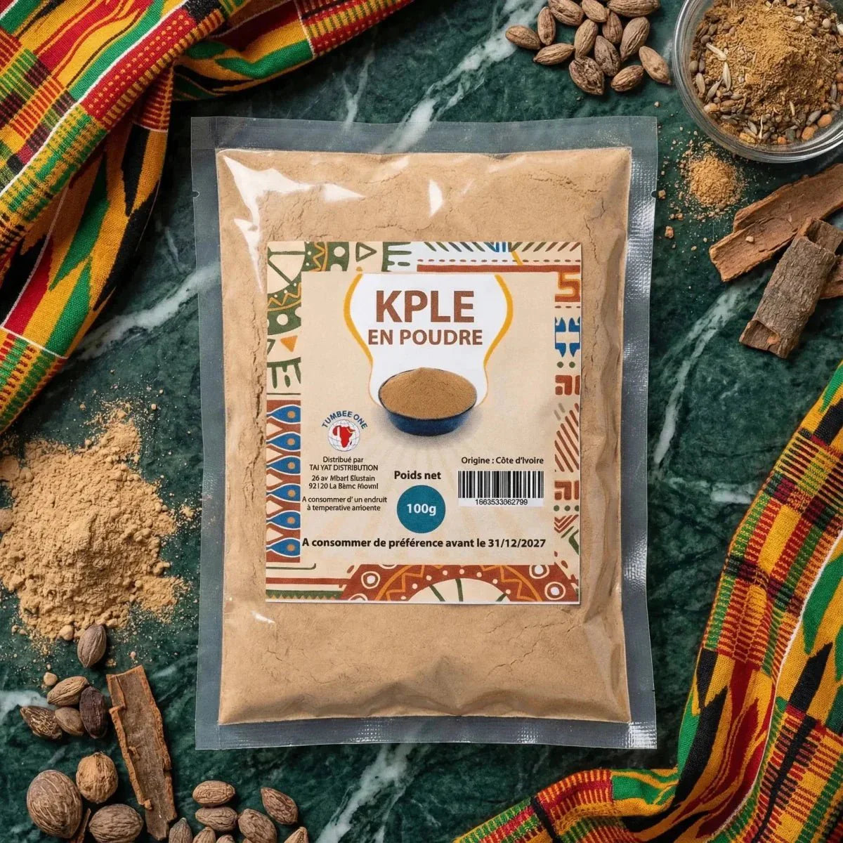 Kpele powder from the brand Tumbee One. 100g pouch on a table with spices.
