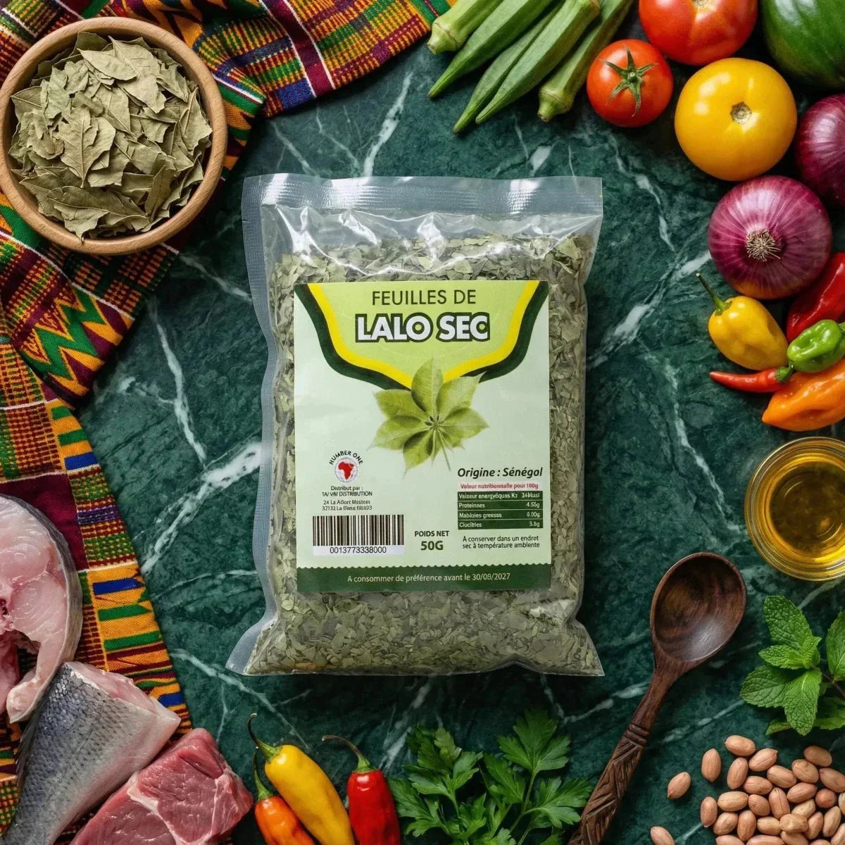 Packet of ground dried Lalo NUMBER ONE surrounded by fresh ingredients: fish, meat, vegetables.