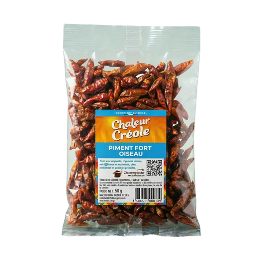 Packet of CHALEUR CREOLE bird's eye hot chili peppers, 50g. The transparent packet shows the dried peppers.