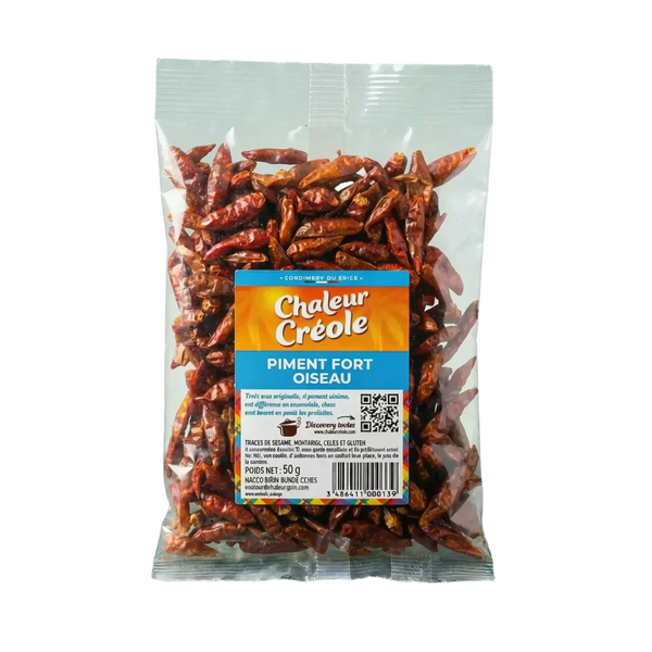 Sachet de piment fort oiseau CHALEUR CREOLE, 50g. Le sachet transparent présente les piments secs.