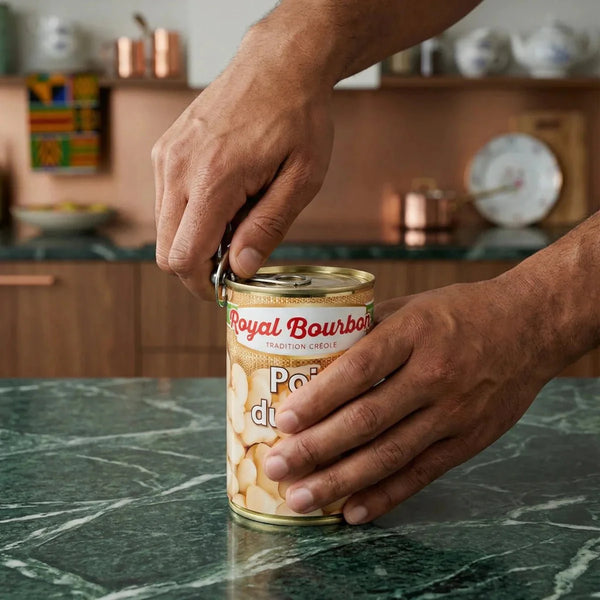 Royal Bourbon Cape Peas, 400g. Hands opening the can on a kitchen counter.