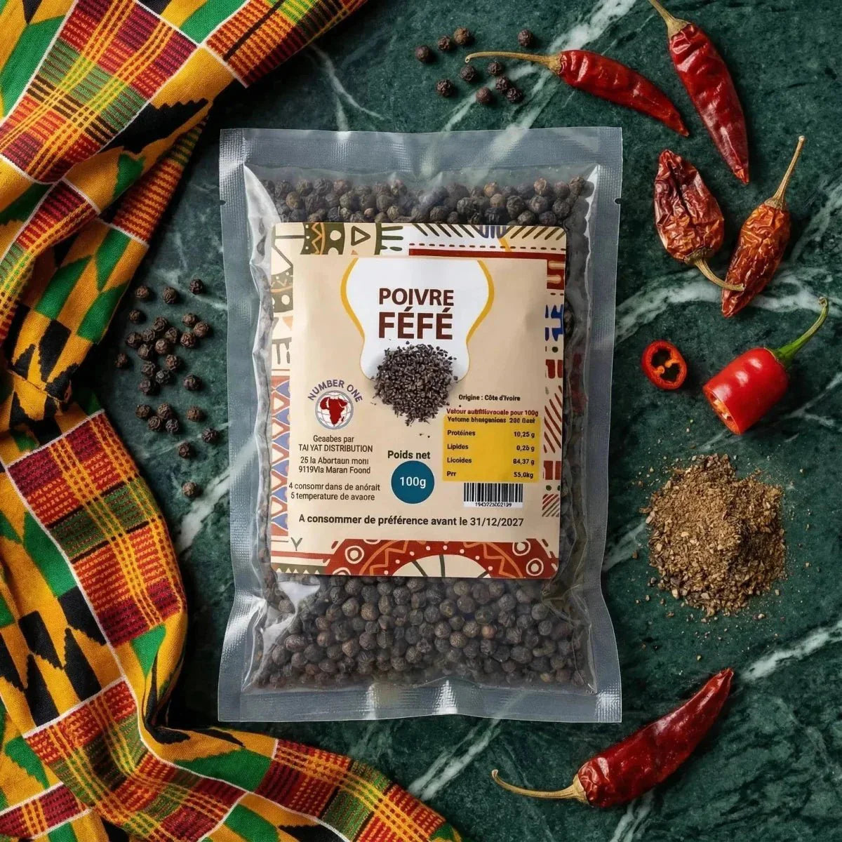 Poivre Fefe NUMBER ONE en sachet sur fond vert marbré, entouré de tissu africain.