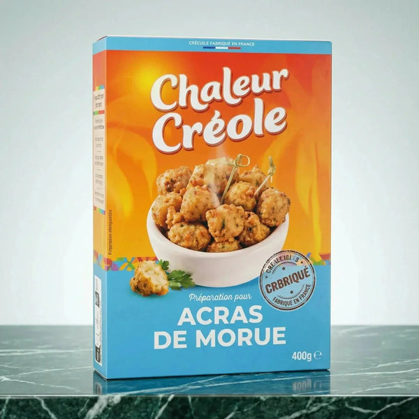 Préparation pour acras de morue par Chaleur Créole, en boîte sur un fond orange et bleu.

