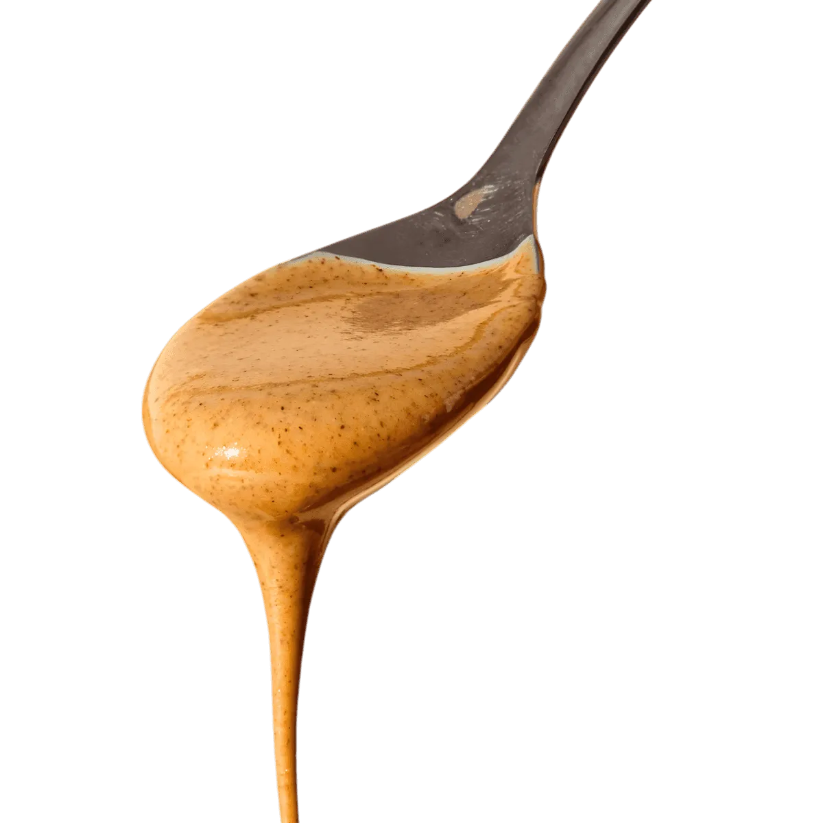 Texture onctueuse de la purée d'amande complète RACINES BIO sur une cuillère, idéale pour recettes sucrées ou salées - ÉPICERIE SUCRÉE NKOSI.