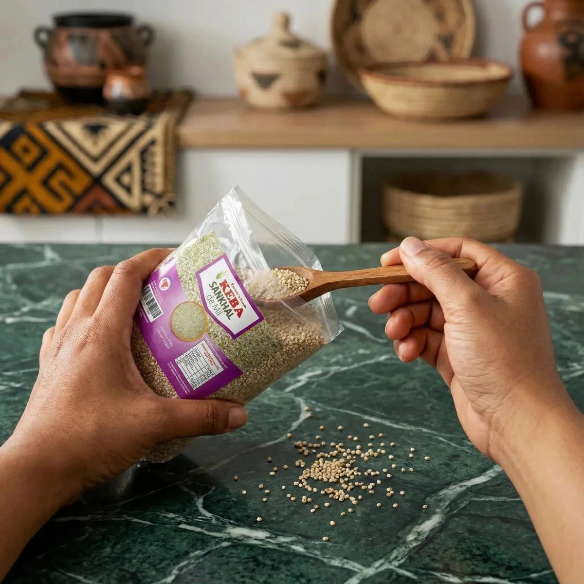 Sankhal de Mil KEBA (500g), mit einem Holzlöffel auf eine grüne Marmorarbeitsplatte geschüttet.