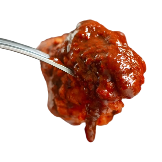 Morceau de viande nappé de sauce carry Royal Bourbon, texture riche et épicée idéale pour recettes créoles et plats mijotés exotiques.