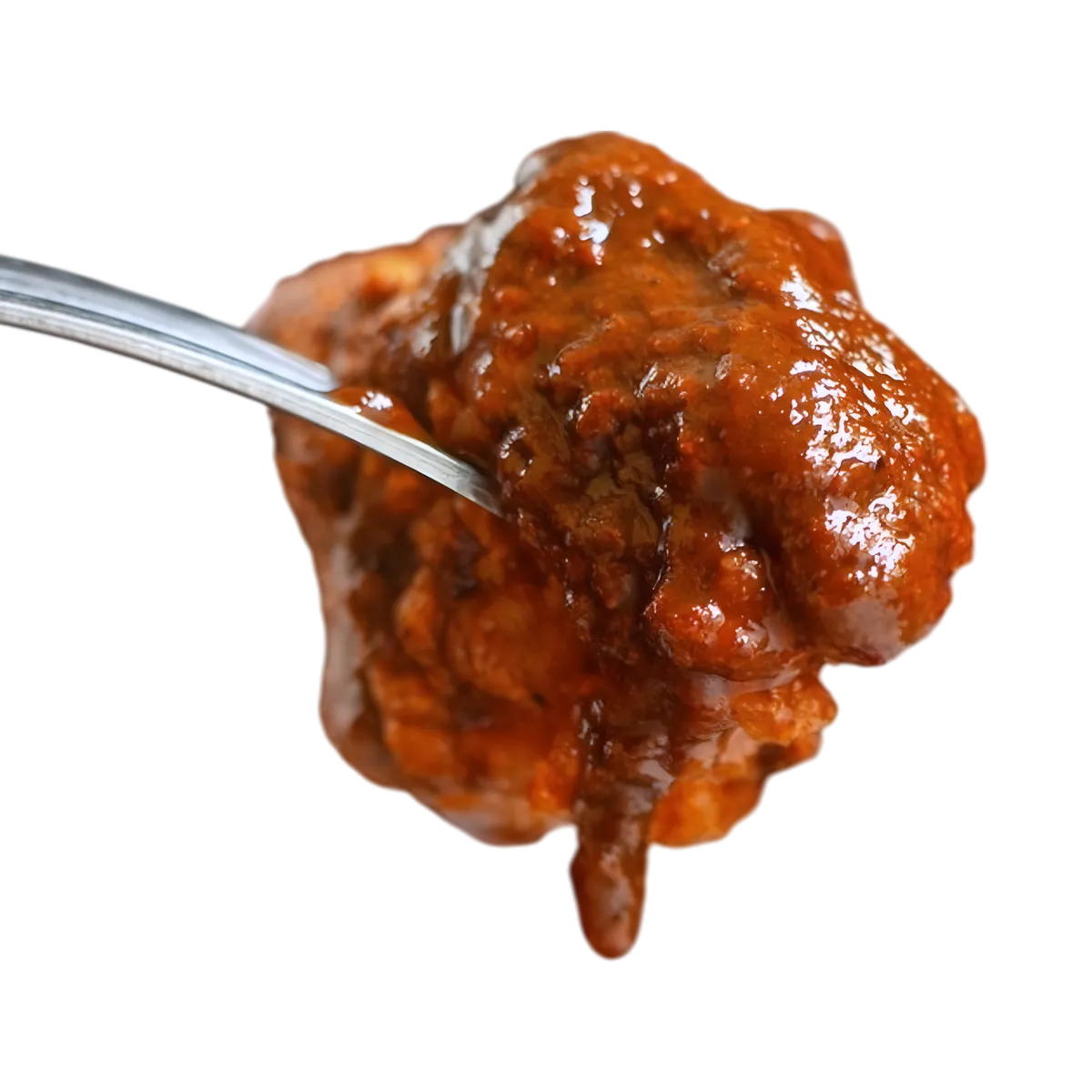 Gros plan sur une bouchée de viande nappée de sauce massalé ROYAL BOURBON, texture onctueuse et épicée pour plats savoureux.