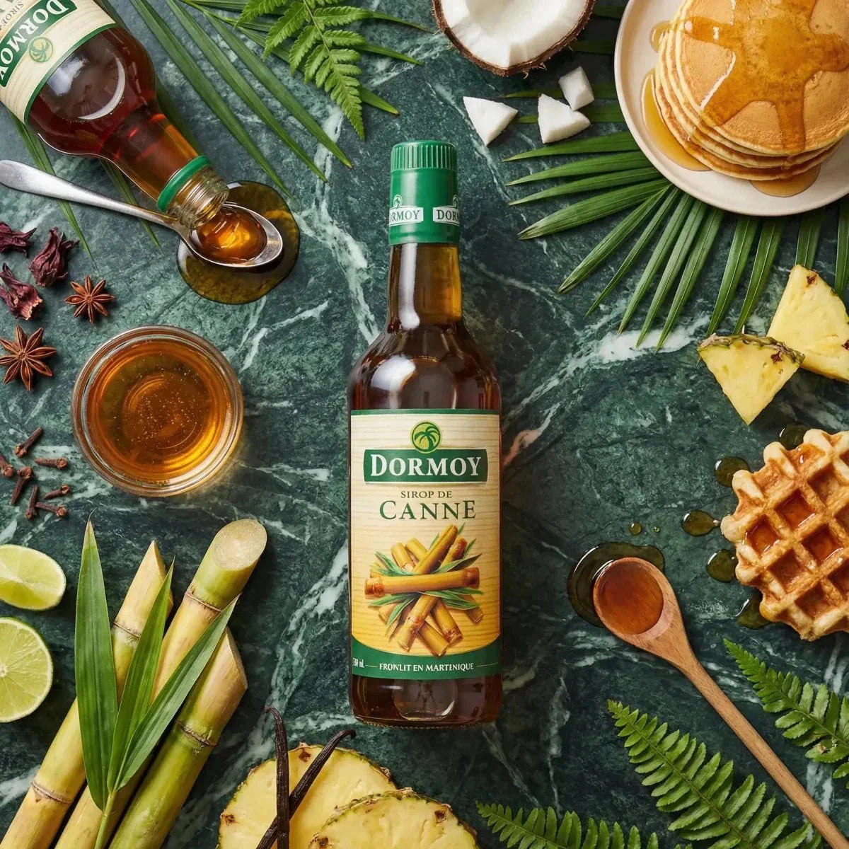 Cane syrup by Dormoy, placed on a green marble surface with waffles.