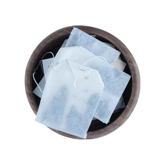 Sachets individuels de Tisane Brûle-graisses DR ERNST'S dans un bol en bois, infusion minceur pour bien-être quotidien.