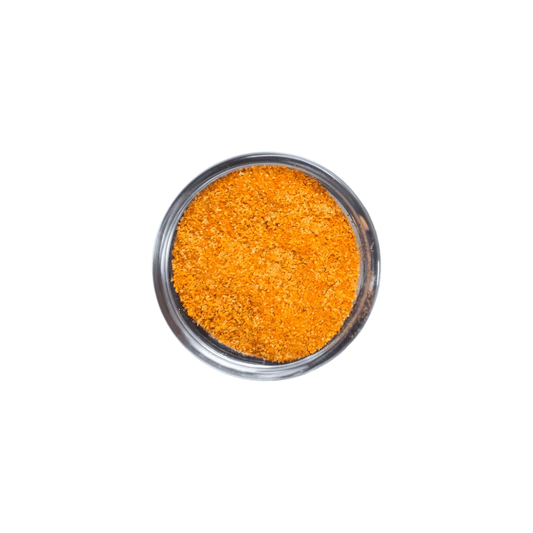 Vue rapprochée du mélange d'épices Tout en 1 Epices JUMBO - ÉPICERIE SALÉE - NKOSI, texture granulée orange idéale pour assaisonner divers plats.