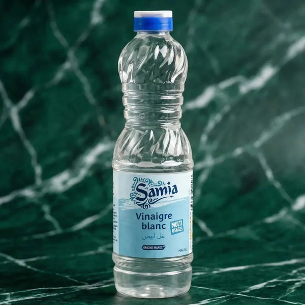 Bouteille de Vinaigre blanc halal SAMIA, 500mL, sur fond vert marbré.