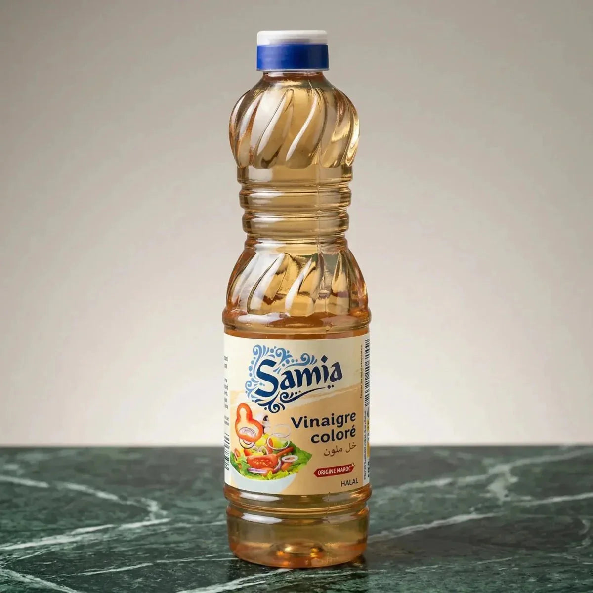 Colored halal vinegar by Samia, in a transparent twisted plastic bottle with a blue cap.